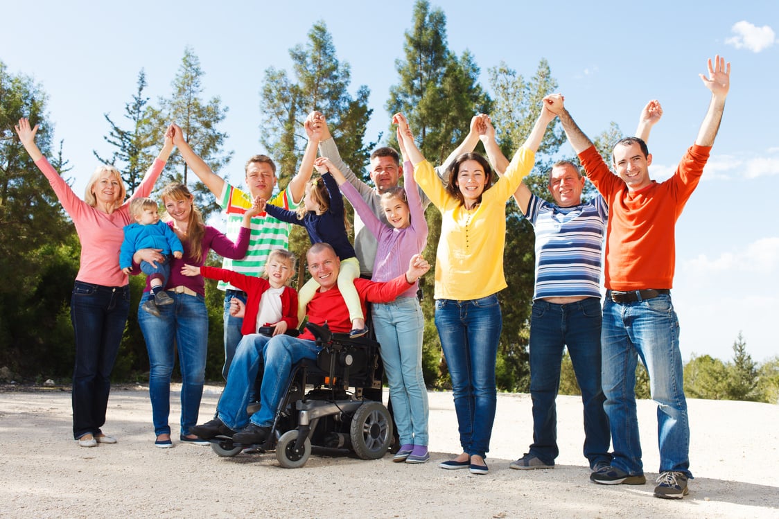 Disabled Man with family outside.